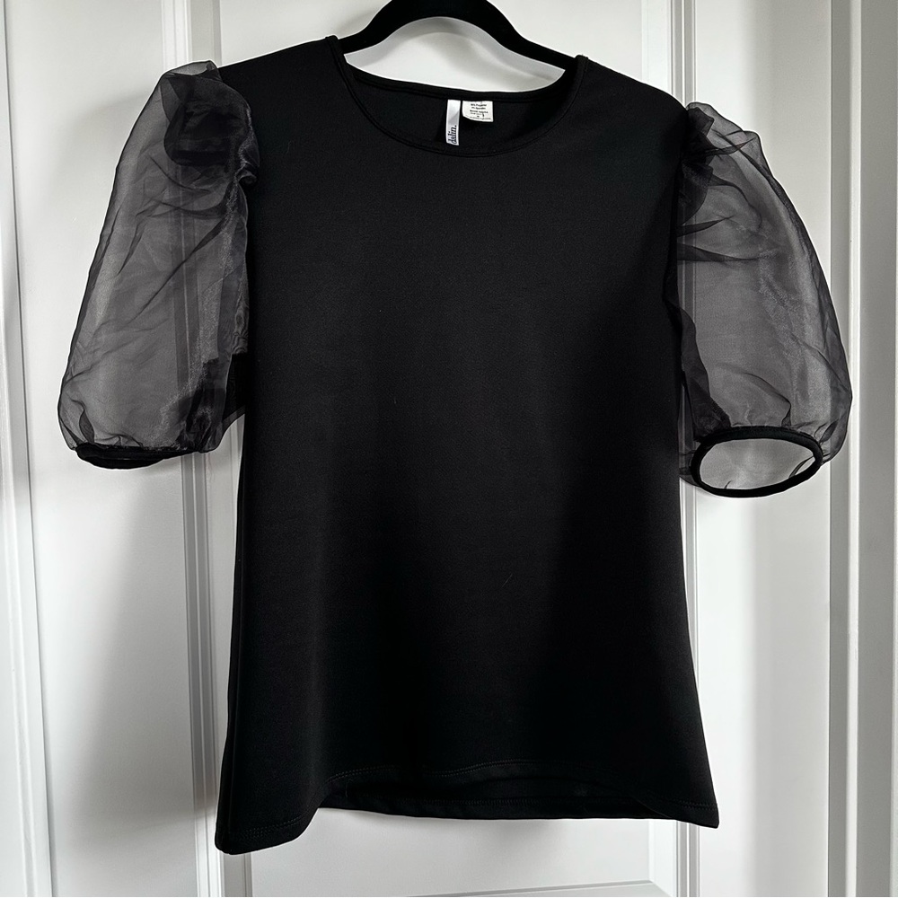 “Little Black Top”. Dress up with a skirt or down with jeans.